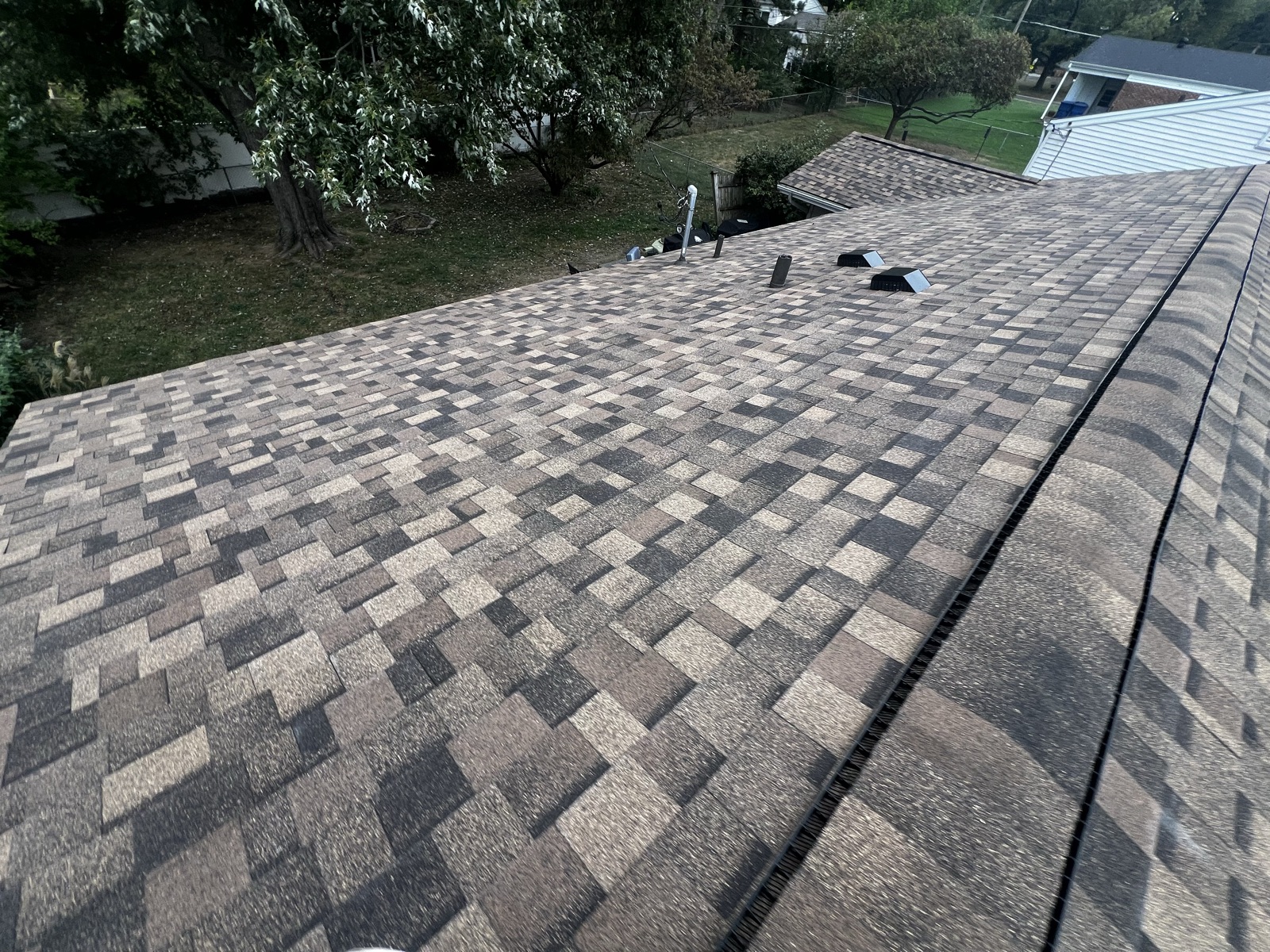 Ridge line and ridge cap inspection on a residential roof
