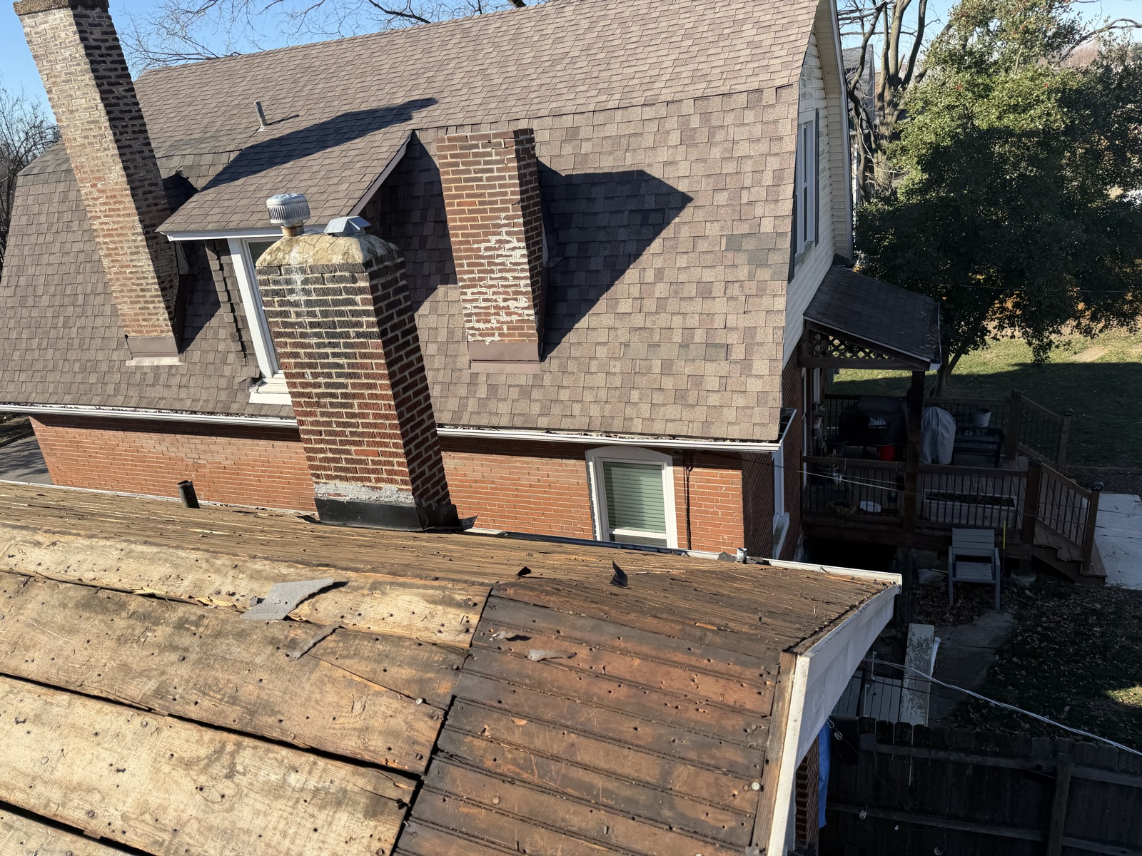 Partially completed tear-off showing exposed roof deck sections