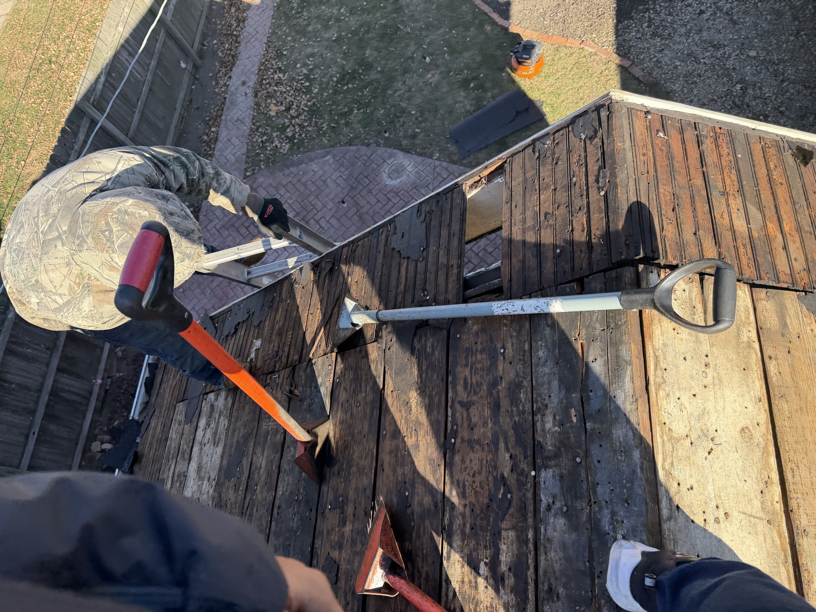 Roofing tools staged on a job site during a tear-off