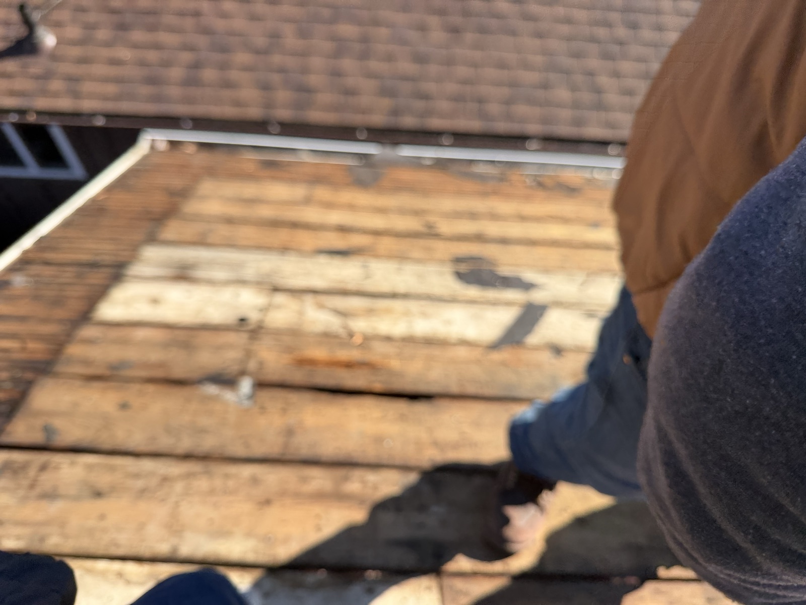 Roofer working through a tear-off on a residential roof